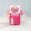 A clear plastic container holds Strawberry Crunch Milkshake - Exclusive- 20 protein muffins from Buffin Bakery, featuring a pink label with nutrition facts and branding, displayed on a white surface against a light background.