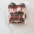 A pack of Protein Buff Pops - Death By Chocolate, featuring a chocolate-themed label with dripping chocolate and truffles, is displayed on a white surface—making it the perfect grab-and-go snack that blends indulgent chocolate cake flavor with the benefits of protein.