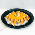 A black plate features the Cheeseburger Bowl: white rice with ground beef, melted orange cheese sauce, mashed potatoes in the center, and fresh green jalapeño slices on top. Gluten-free.