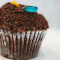 Introducing the Buffin Muffin Dirt Cake: a decadent chocolate muffin cupcake crowned with crumbled chocolate cookies and vibrant gummy worms, perfectly capturing the playful “dirt and worms” look. This nostalgic dessert classic is ideal for anyone craving a sweet throwback treat.