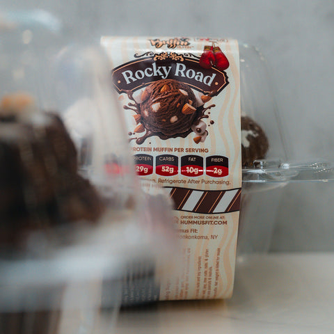 VIP Buffin - Rocky Road’s clear plastic container displays a chocolate muffin with nuts on the label. Each macro-friendly snack has 29g protein, 5g carbs, 10g fat, and 2g fiber. Refrigerate after purchase.