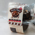 A clear plastic container holds a VIP Buffin - Rocky Road high protein chocolate muffin. The label displays nutritional info: 416 calories, 29g protein, 52g carbs, and 10g fat per serving, with branding and a chocolate-themed graphic.