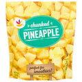 A bag of Frozen Pineapples- For Shakes features green and white labeling, a background image of pineapple pieces, the brand's logo, and highlights that it's perfect for smoothies.