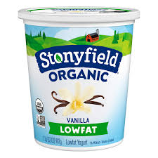 A container of LOW FAT VANILLA YOGURT-FOR SHAKES with vanilla flowers and pods pictured on the front, featuring a blue and green farm-themed design with a small red barn.