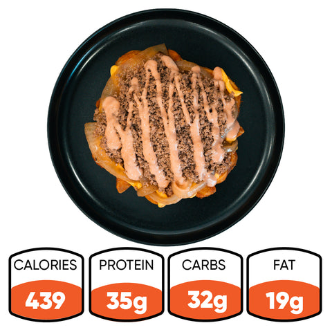 A black plate with a layered Animal Style West Coast Beef Bowl topped with sauce. This macro-friendly, high-protein meal prep option delivers 439 calories, 35g protein, 32g carbs, and 19g fat.