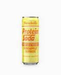 A yellow can of BAREBELLS PROTEIN SODA in Pineapple Sunrise flavor features bold orange and white text, highlighting its caffeine, protein content, carbonation, and sugar-free formula.