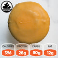 The Buffalicious Baddie Buffin Muffin pastry, shown with a smooth golden glaze from above, is highlighted as an ideal pre- or post-workout snack: 396 calories, 28g protein, 50g carbs, and 12g fat.