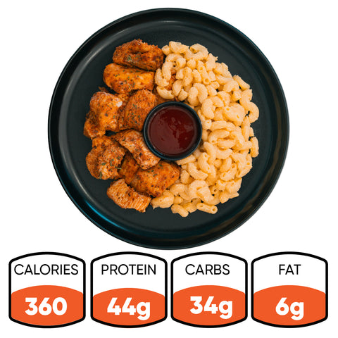 Buffalo Mac N Chicken: Grilled chicken, mac and cheese, and sauce in a black plate. This high-protein meal has 360 calories, 44g protein, 34g carbs, and 6g fat.