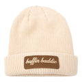Stay warm and stylish in the Buffin Baddie Brown Patch Beanie—a cream rib-knit beanie with a folded brim and brown "buffin baddie" patch, ideal for cold-weather training or upgrading your athleisure look.