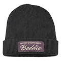 The Buffin Bakery “Baddie” Script Beanie features a black rib-knit design with a folded brim and a purple patch that reads PROPERTY OF BUFFIN BAKERY Baddie—ideal for athleisure or gym-to-street style.