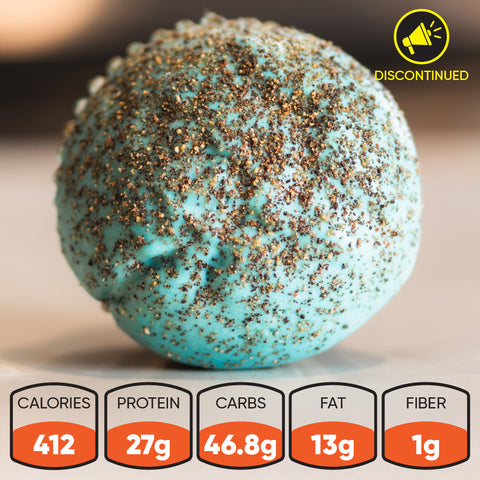 A close-up of a Buffin Muffin Beastly Cookie Gains protein snack ball discontinued with dark specks—ideal for pre or post workout. Nutrition icons: 412 calories, 27g protein, 46.8g carbs, 13g fat, 1g fiber.