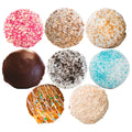 Buffin Muffin Sampler Pack containing eight assorted muffins with toppings including pink sprinkles, coconut, icing, chocolate glaze, cookie crumbles, blue sugar, and cinnamon crumb.