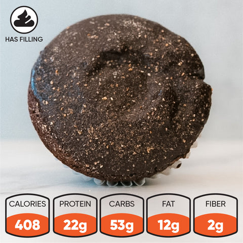 A close-up of the Buffin Muffin - TwistBar, a chocolate caramel protein muffin with gooey filling. Nutrition: 408 calories, 22g protein, 53g carbs, 12g fat, 2g fiber. A "has filling" icon is displayed in the upper left corner.