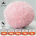 The Welcome to the Sno is a large pink, coconut-covered protein dessert ball with a filling and nuts, served on a white surface. Nutrition: 424 cal, 25g protein, 54g carbs, 12g fat, 2g fiber.
