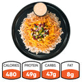 The Chicken Taco Bowl is a high-protein meal with rice, shredded chicken, cheddar cheese, beans, and vegetables served on a black plate with sauce. Nutrition: 480 calories, 49g protein, 47g carbs, 8g fat.