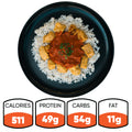 A black plate of Chicken Tikka Masala with white rice and herbs. This gluten free, high protein meal contains 511 calories, 49g protein, 54g carbs, and 11g fat—nutrition facts shown below the plate.