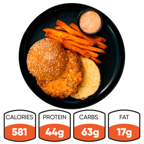 The Chicken Veggies Burger features a sesame seed bun chicken burger, sweet potato fries, and dipping sauce. Nutrition: 581 calories, 44g protein, 63g carbs, and 17g fat—making it a high-protein, satisfying meal.