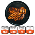 A serving of Chipotle Chicken 1lb Competition Approved arranged on a black plate offers a healthy dinner with 162 calories, 33g protein, 3g carbs, and 2g fat.