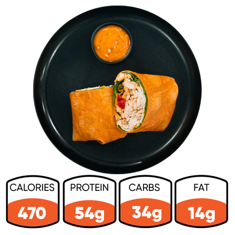 The Club Wrap, shown halved on a black plate with orange dipping sauce, has 470 calories, 54g protein, 34g carbs, and 14g fat—ideal for meal prep.