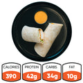 A black plate displays a sliced Crispy Baked Chicken Wrap and dipping sauce. Nutrition: 390 calories, 42g protein, 34g carbs, 10g fat—ideal for healthy meal prep or a high-protein lunch.