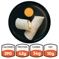 The Crispy Baked Chicken Wrap sits on a black plate with orange dipping sauce; nutrition info per serving: 390 calories, 42g protein, 34g carbs, and 10g fat—an ideal high-protein lunch for healthy meal prep.
