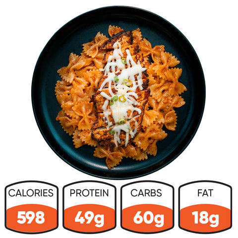 Farfalle Chicken Alfredo: High-protein pasta in creamy sauce with grilled chicken, melted cheese, and green onions. Ready-to-heat meal with 598 calories, 49g protein, 60g carbs, and 18g fat.