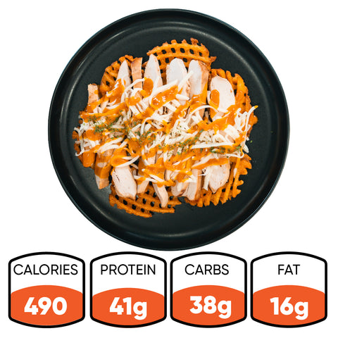 Introducing the Fit-Fil-A: A plate of baked waffle fries loaded with tender smoked chicken breast, shredded cheese, and zesty orange sauce. Each serving provides 490 calories, 41g protein, 38g carbs, and 16g fat—perfect for a healthy dinner.