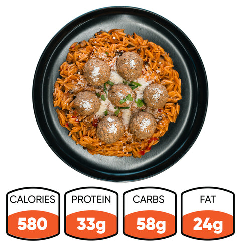 Garden Orzo Meatballs features orzo pasta in red sauce, topped with seven meatballs and grated cheese—a high-protein meal prep option with 580 calories, 33g protein, 58g carbs, and 24g fat per serving.