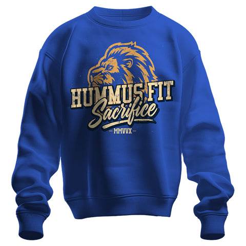The 2025 Hummus Fit Sacrifice Lion Crewneck in royal blue is made from mid-weight fleece and showcases a bold lion’s head graphic with "HUMMUS FIT Sacrifice MMVVX" in large gold and white distressed lettering on the chest.