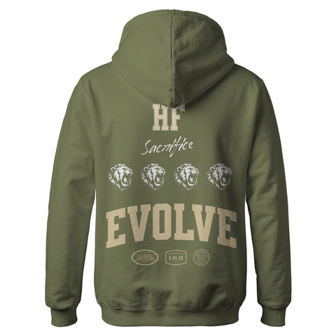 The Hummus Fit Varsity EVOLVE Hoodie Olive is a mid-weight fleece featuring “HF,” “Sacrifice,” three lion heads, bold “EVOLVE” text on the back, and multiple small logos and badges near the hem.