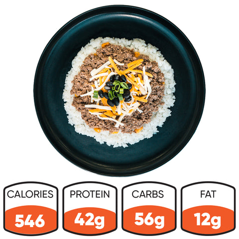 The Honey Garlic Beef Bowl features white rice, ground meat, shredded cheese, black beans, and green onions. This high-protein meal prep option has 546 calories, 42g protein, 56g carbs, and 12g fat.
