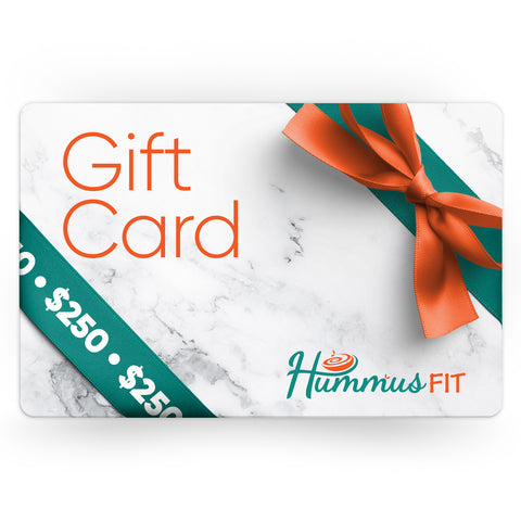 A rectangular Hummus Fit Gift Card with orange ribbon and bow, green ribbon with “250,” and logo on a marble background—an ideal fitness gift for healthy eating enthusiasts.