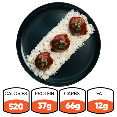 A black plate featuring white rice topped with Caribbean Jerk Meatballs in red sauce and cilantro. Nutrition: 520 calories, 37g protein, 66g carbs, 12g fat—ideal as a high-protein Caribbean Jerk Meatballs rice bowl meal prep.