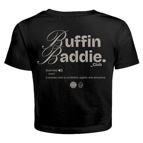 The Buffin Baddie Club Definition Crop Tee — Black is a streetwear baby-tee displaying Buffin Baddie Club text, a definition for confident, stylish, attractive women, and two globe icons beneath the print.