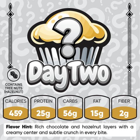 Buffin Muffin Mystery Flavor, Day 2: Illustration shows a cupcake with a question mark. Contains tree nuts hazelnut. Nutrition: 459 calories, 25g protein, 56g carbs, 15g fat, 2g fiber. Flavor hint: chocolate and hazelnut.