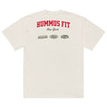 Back view of an off-white t-shirt with HUMMUS FIT in large red letters, New York below in black script, and three sponsor logos—Slickfade, EVOLVE, and LIONS CLUB—printed underneath.