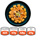 A black plate holds Peak Load Chick'n Tots—crispy tater tots in a circle around pulled chicken with cheese, beans, and green onions. Nutrition: 623 calories, 47g protein, 48g carbs, 27g fat. A high-protein meal.