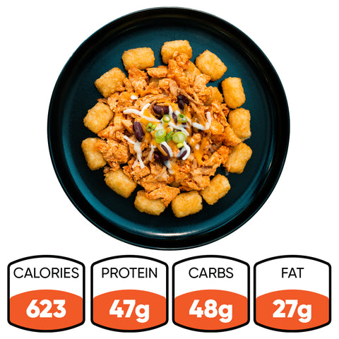 A black plate holds Peak Load Chick'n Tots—crispy tater tots in a circle around pulled chicken with cheese, beans, and green onions. Nutrition: 623 calories, 47g protein, 48g carbs, 27g fat. A high-protein meal.