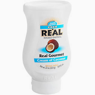 A squeezable white bottle labeled "Coconut CREAM-For Shakes" with a coconut image and blue accents, containing 22 ounces.