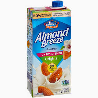 A carton of Almond Milk- For Shakes with a blue cap, almonds splashing into milk on the front, and various nutrition and certification labels.
