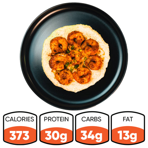 Shrimp and Gritz, a Southern-style dish, is served on a black plate and photographed from above. Nutrition: 373 calories, 30g protein, 34g carbs, and 13g fat.