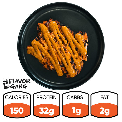 Competition Approved Grilled Chicken W/ Smokin Poppie Sauce 1lb: 150 calories, 32g protein, 1g carbs, 2g fat. The Flavor Gang logo is on the left. Enjoy this high-protein, low-carb meal topped with thick orange sauce.