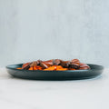 The Soho Steak Bowl features sliced steak with barbecue sauce over mashed sweet potatoes, served on a dark plate for a healthy, Asian-inspired lunch—presented on a white surface against a light gray background.