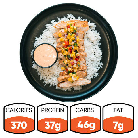 The Southwest Chicken Bowl features white rice, sliced grilled chicken, and corn salsa in a black bowl with a side of sauce. Gluten-free and great for meal prep. 370 calories, 37g protein, 46g carbs, and 7g fat.