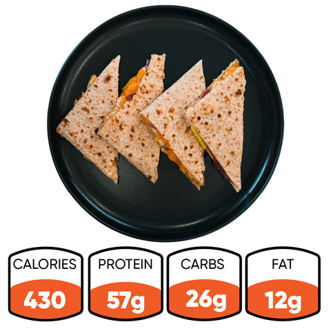 Four triangular sandwich pieces on a black plate, made with the Strongsville Chicken Ranch Fold for a delicious high-protein meal. Nutrition info below: 430 calories, 57g protein, 26g carbs, and 12g fat.