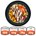 Introducing the Texas Queso Steak Bowl: a hearty, naturally gluten-free meal served on a black plate and loaded with rice, grilled beef, sautéed peppers and onions, corn, beans, and a rich white queso sauce. Each bowl delivers 508 calories with 44g of protein, 38g of carbohydrates, and 20g of fat.