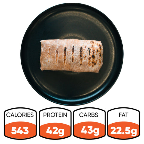 The Arches Mac Daddy Wrap—a grilled burrito served on a black plate—delivers cheeseburger-inspired flavor in every bite, packing 543 calories, 42g protein, 43g carbs, and 22.5g fat for a perfect macro-friendly lunch.
