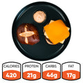 A high-protein breakfast twist: the Vegan Breakfast Sandwich on a pretzel bun with sauce, served on a black plate. With 420 calories, 21g protein, 46g carbs, and 17g fat, this healthy vegan option is an energizing way to start your day.